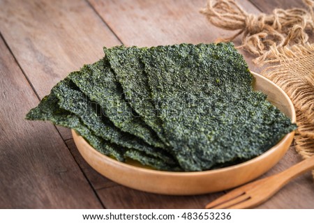 Crispy dried seaweed on wooden plate