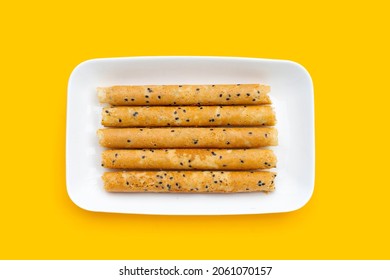 Crispy Egg Rolls In White Plate On Yellow Background.