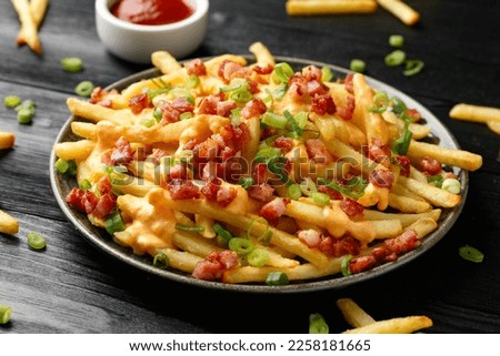Crispy French fries loaded with bacon, cheese sauce and spring onion