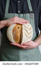 Crispy Fresh Bread In The Hands Of A Man. Rustic Organic Wheat Bread. Gluten Free. Home Baking Bread Closeup. Delicious Natural Foods, Healthy Food Baking. Small Business And Slow Food Concept.