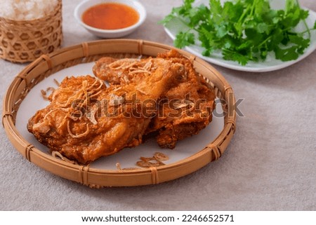 Crispy fried chicken with deep fried shallot in wicker basket (Hat Yai fried chicken), Thai food style
