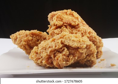 crispy fried chicken on a white plate