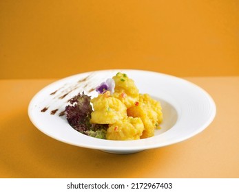 Crispy Fried Crystal Prawns Tossed With Salted Egg Yolk With Chopsticks Served In A Dish Isolated On Mat Side View On Grey Background