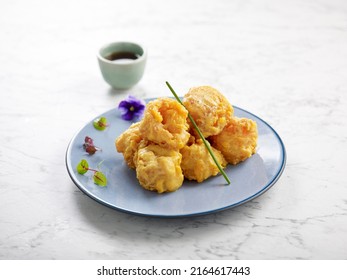 Crispy Fried Prawns Tossed With Salted Egg Yolk Served In A Dish With Chopsticks Side View On Grey Background