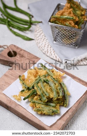 Crispy green bean tempura served on a chopboard. Stock photo © 