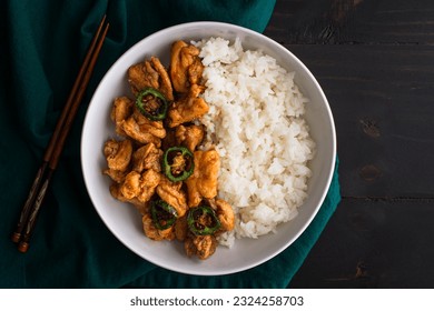 Crispy Hawaiian Garlic Chicken Served with Jasmine Rice: Fried chicken thighs in garlic-soy sauce served with fried jalapeno peppers and white rice