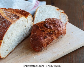 Crispy Heel Of An Artisan Potato Bread Loaf On Wooden Board