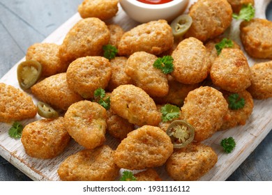 Crispy Jalapeno Popper with creamy cheese battered on white wooden board