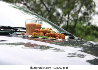 Crispy Moong Pakora, Delicious Street Food, Favourite Indian Snack In Monsoon Serve With Hot Tea. Kept On Car's Bonnet 