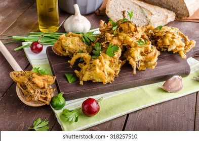 Crispy onion bhajis, delicious street food, with herbs and garlic
