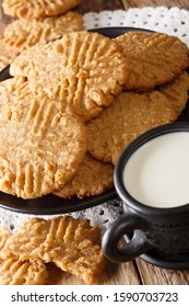 Crispy Peanut Butter Cookies With A Cup Of Milk Close-up On The Table. Vertical
