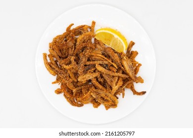 Crispy Pig Ears With Lemon On A White Plate