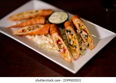 Crispy Plate Of Fried Southwest Eggroll Appetizer At A Restaurant