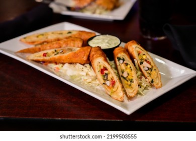 Crispy Plate Of Fried Southwest Eggroll Appetizer At A Restaurant