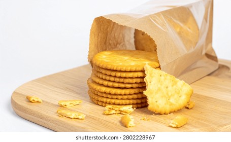 Crispy round biscuit crackers with stack and broken pieces, paper plastic takeaway bag package, wooden serving board isolated mockup.