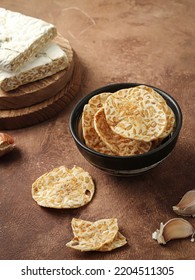 Crispy Tempeh Chips In A Bowl, And Raw Tempeh