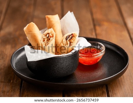 Crispy Vegetable Spring Rolls with Sweet Chili Dipping Sauce in plate side view of Asian Appetizer