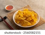 Crispy wonton,Deep Fried Crispy Prawn Wontons sheet on white plate with Sweet Chili Sauce.asian snack food.