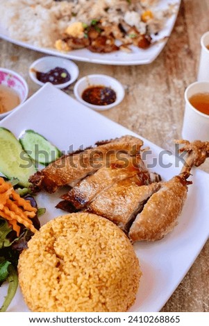Crispy-skin chicken Maryland with tomato rice and combination broken rice with pork chop, condiments and tea at Gia Long, a Vietnamese restaurant in Homebush, Sydney
