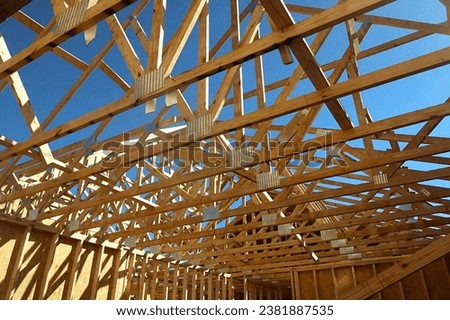 Criss-Cross of Wooden Beams on New Home Construction.