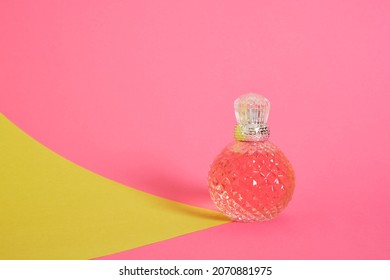 Cristal Glass Perfume Bottle On Pink Background Copy Space