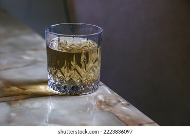 Cristal Glass With Some Light Drink On The Table 