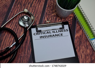 Critical Illness Insurance Write On Paperwork Isolated On Wooden Table.