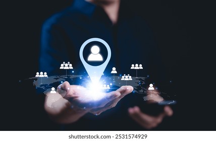 CRM concept. Customer relationship management technology. Businessman holds digital network user icons on global map, customer relationship management, global networking, customer targeting, map pin,
