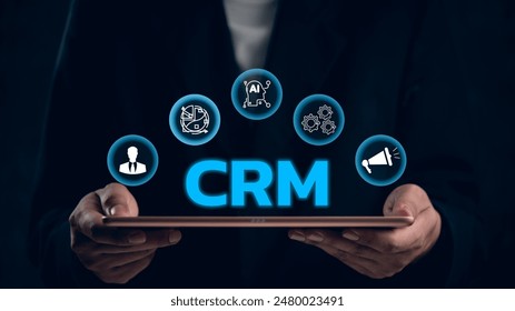 CRM concept with icons around a tablet, illustrating customer relationship management. Ideal for business strategy, marketing, sales, service automation. Digital integration solution.