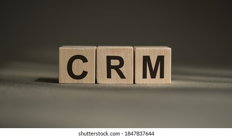 CRM, Customer Relationship Management, Loyalty Program, Repeat Purchase Frequency Concept, On Wooden Blocks Over Gray Background.