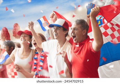 Croatia football supporter on stadium. Croatian fans cheer on soccer pitch watching winning team play. Group of supporters with flag and national jersey cheering for Croatia. Championship game victory - Powered by Shutterstock