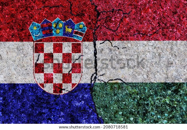 Croatia and Hungary painted flags on a wall\
with grunge texture. Hungary and Croatia conflict. Croatia and\
Hungary flags together. Hungary vs\
Croatia