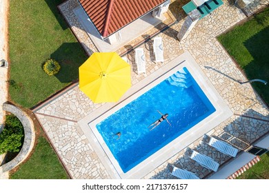 Croatia, Istria, Pula, mother and daughter swimming at the pool, birds eye view - Shutterstock ID 2171376157