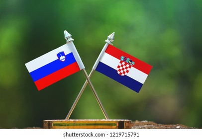 Croatia And Slovenia Small Flag With Blur Green Background