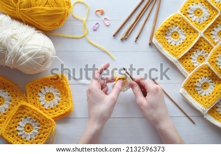 Crochet handmade granny square pattern, crocheting supplies, assorted colored wool yarn, hook, knitting crocheting