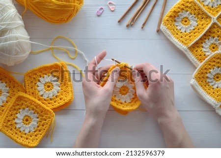 Crochet handmade granny square pattern, crocheting supplies, assorted colored wool yarn, hook, knitting crocheting