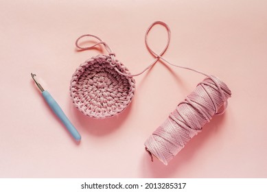 Crochet Hook And Pink Color Yarn On A Pink Background, Knitting And Crochet Supplies, Hobby And Craft