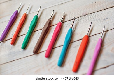 Crochet Hooks On A Wooden Background