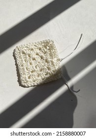 Crochet Square Of White Cotton Yarn On A White Background