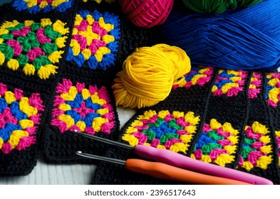 Crochet texture, thread rolls and hooks. Colorful cotton granny square. Hand knitted zigzag jewelry, a favorite hobby. - Shutterstock ID 2396517643