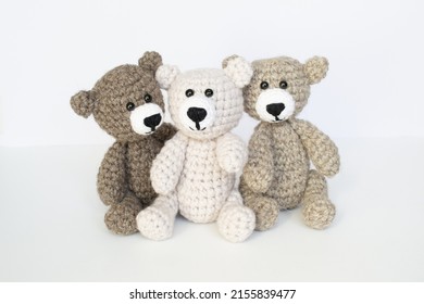 Crocheted gray and brown bears on a white background. Crocheted toy. - Shutterstock ID 2155839477