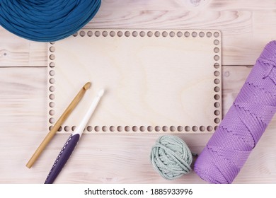 Crocheting supplies, hooks, empty blank wooden desk with trendy colors yarn and cord. Background for hobby presentations.Knitting crochet and diy concept. - Powered by Shutterstock