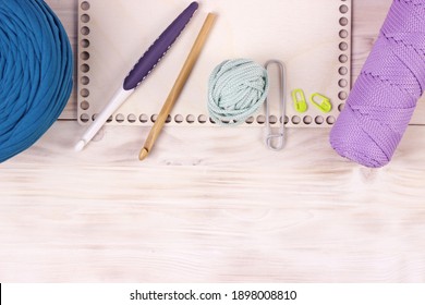 Crocheting supplies, hooks, empty blank wooden desk with trendy colors yarn and cord. Background for hobby presentations.Knitting crochet and diy concept.Copy space for text. - Powered by Shutterstock