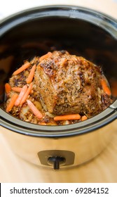 A Crock Pot With A Beef Pot Roast And Vegatables