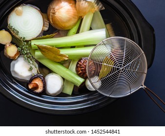 Crock Pot With Healthy Broth Ingredients.