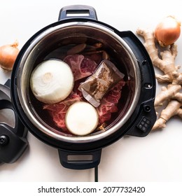 Crock pot instant pot pressure cooker with onions meat and spices