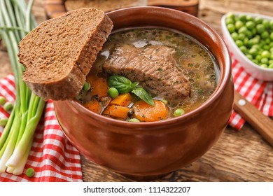 Crock Pot With Stewed Meat On Table