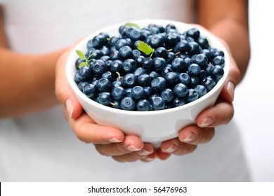 Crockery With Blueberries In Woman Hands.