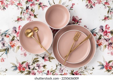 Crockery and cutlery on a white tablecloth with floral pattern, table top view, above. Flat lay design. Ceramic empty plates, utensils for serving. Trendy tableware set for serving, beige luxury dish. - Powered by Shutterstock