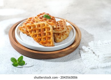 Croffle or croissant waffle is a dessert where croissant raw is baked in a waffle pan. Selective focus.